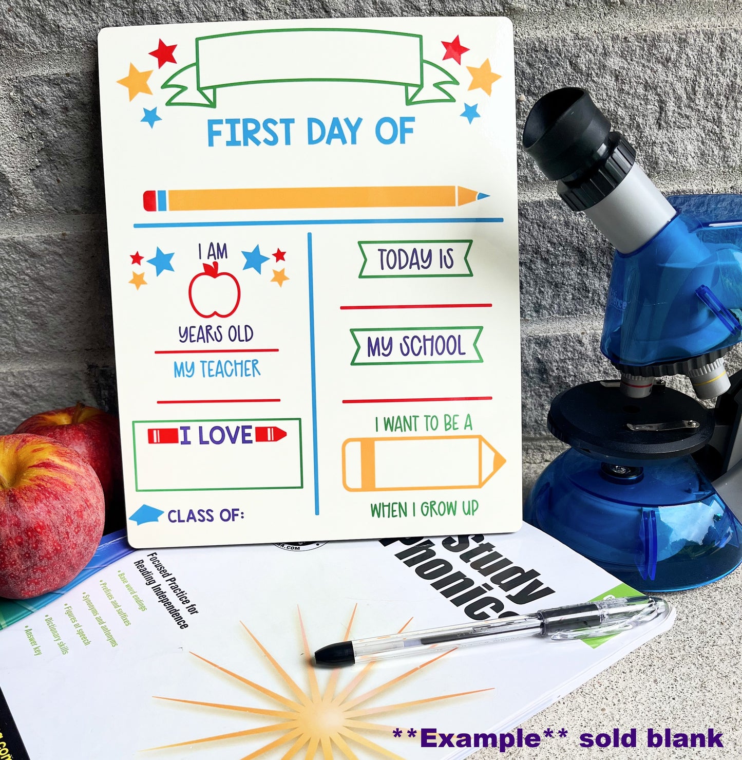 first day of school board with school book apple pen and microscope on brick background