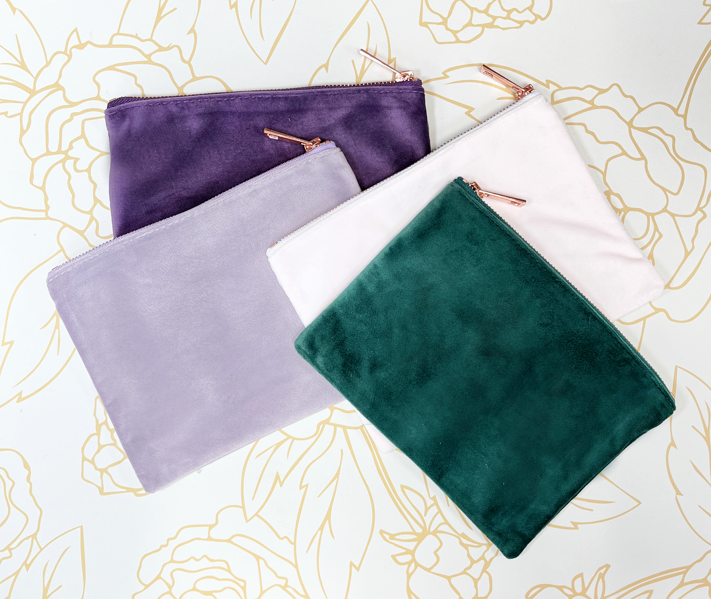 velvet make up cases with rose gold zippers purple lilac blush and green on gold flower background