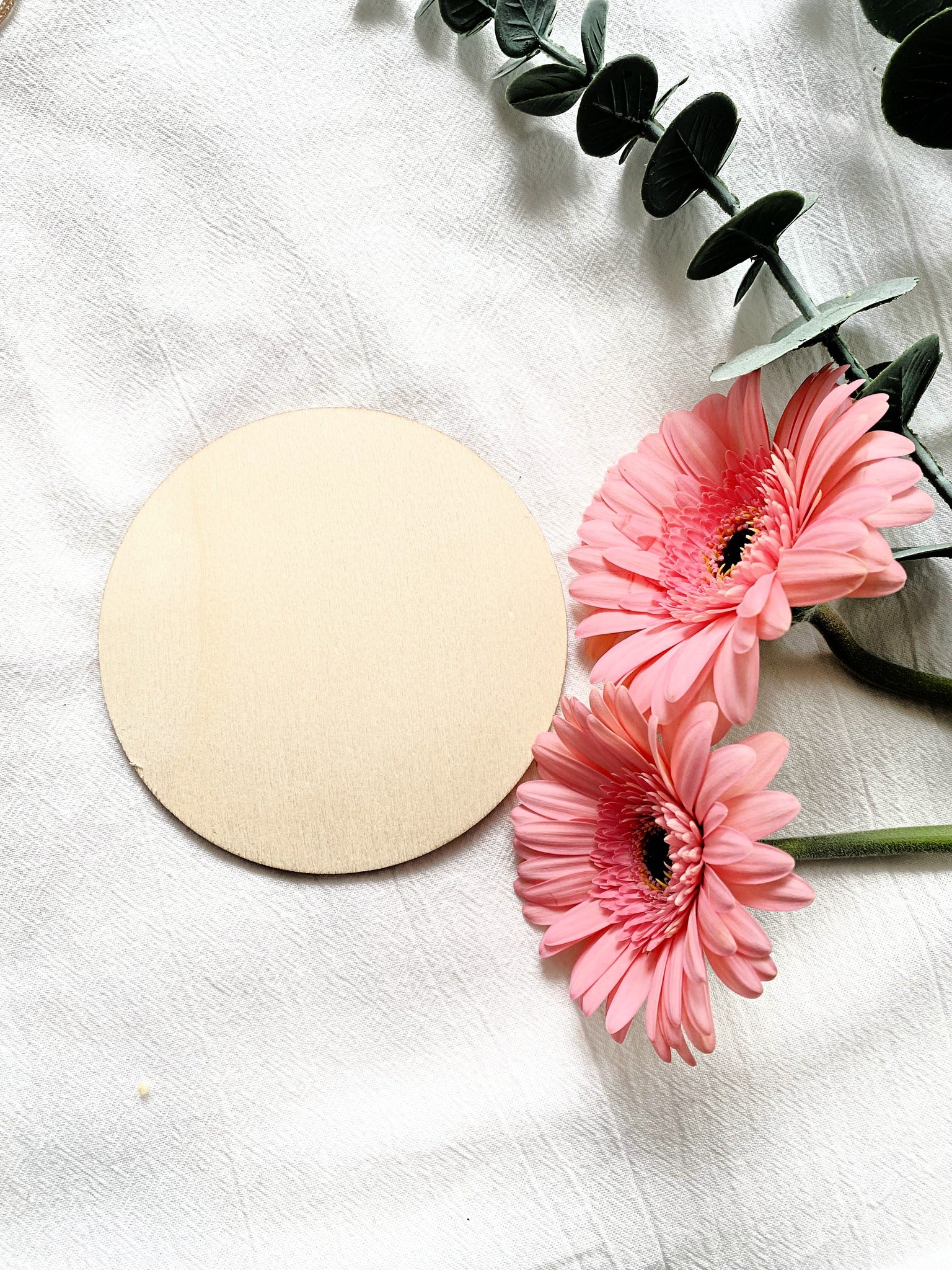 wood circle on white background with pink flowers