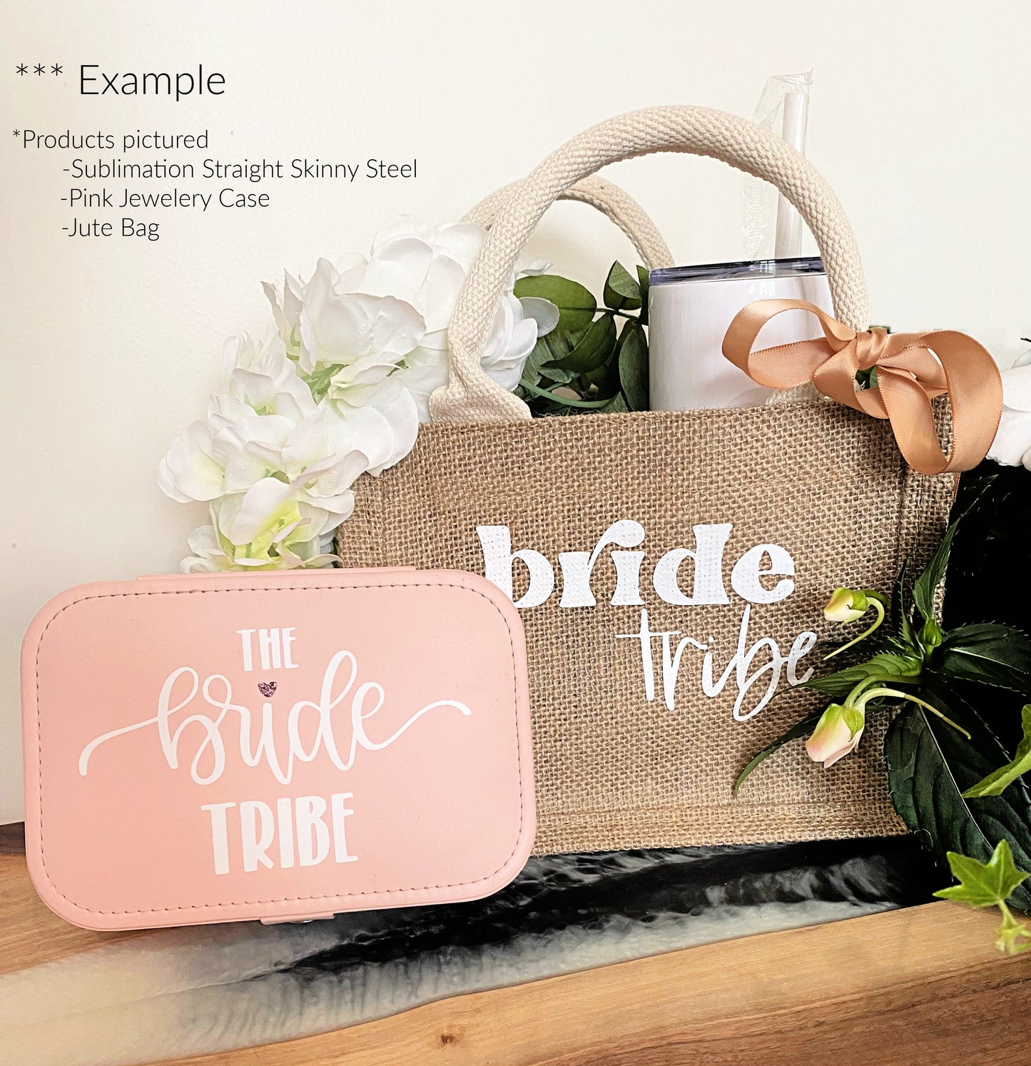 jute gift bag set for bride with bow tumbler jewellery case and white flowers on wood table and white background 