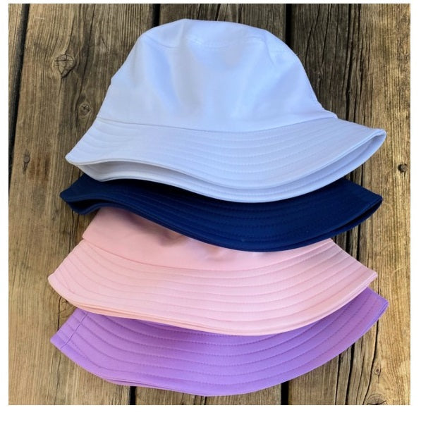 kids bucket hats white blue pink and purple wood background