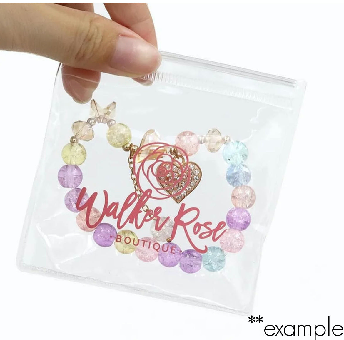 hand holding personalized clear pvc zipper pouch with jewellery inside