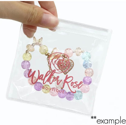 hand holding personalized clear pvc zipper pouch with jewellery inside