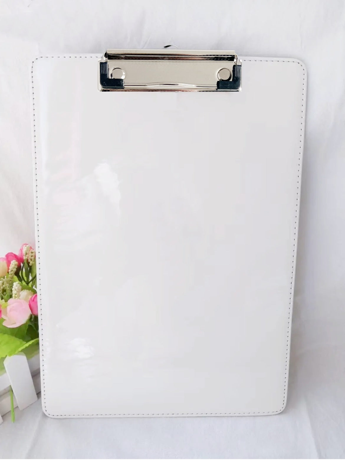 white sublimation clipboard on white background with flowers