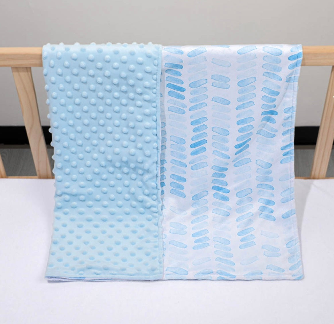 double sided blue minky baby blanket over wood crib ,blue dots and blue lines