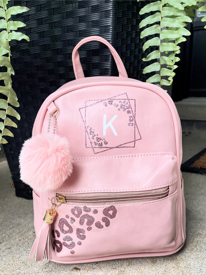 mini pink leather backpack personalized with cheetah print and initial .with pompom and tassle