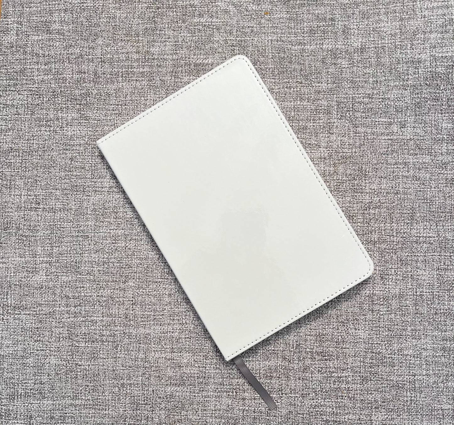 white sublimation journal with grey marker on a grey background