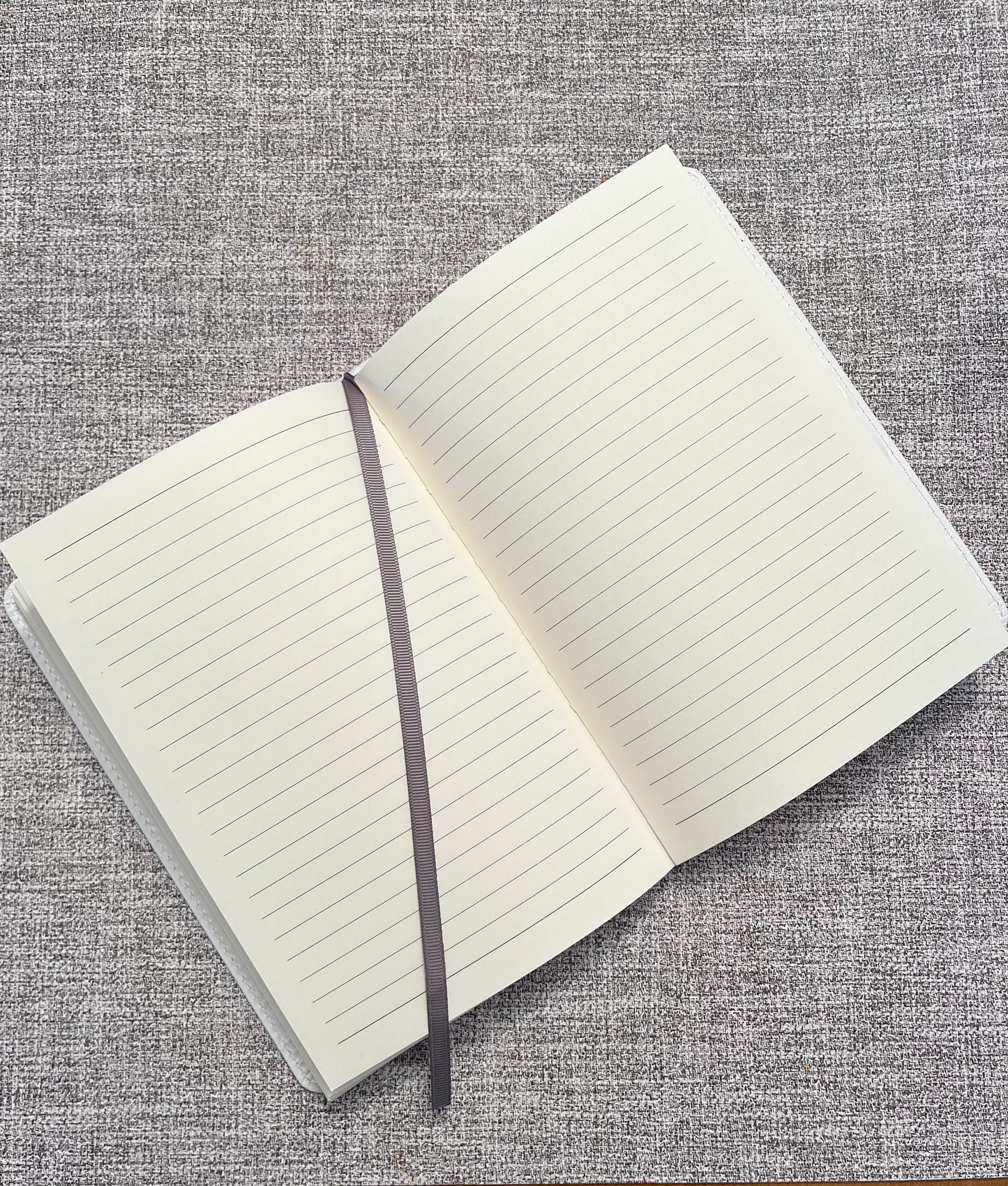 lined journal with page marker on grey background