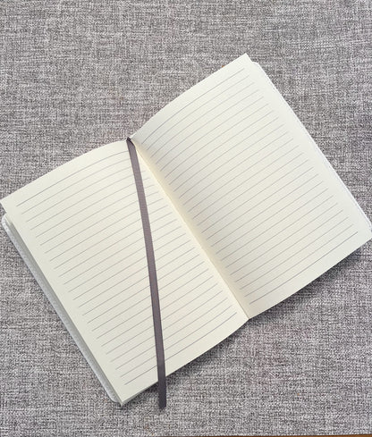 lined journal with page marker on grey background