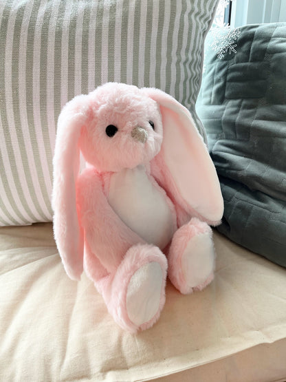 floppy ear pink sublimation bunny sitting on pillow