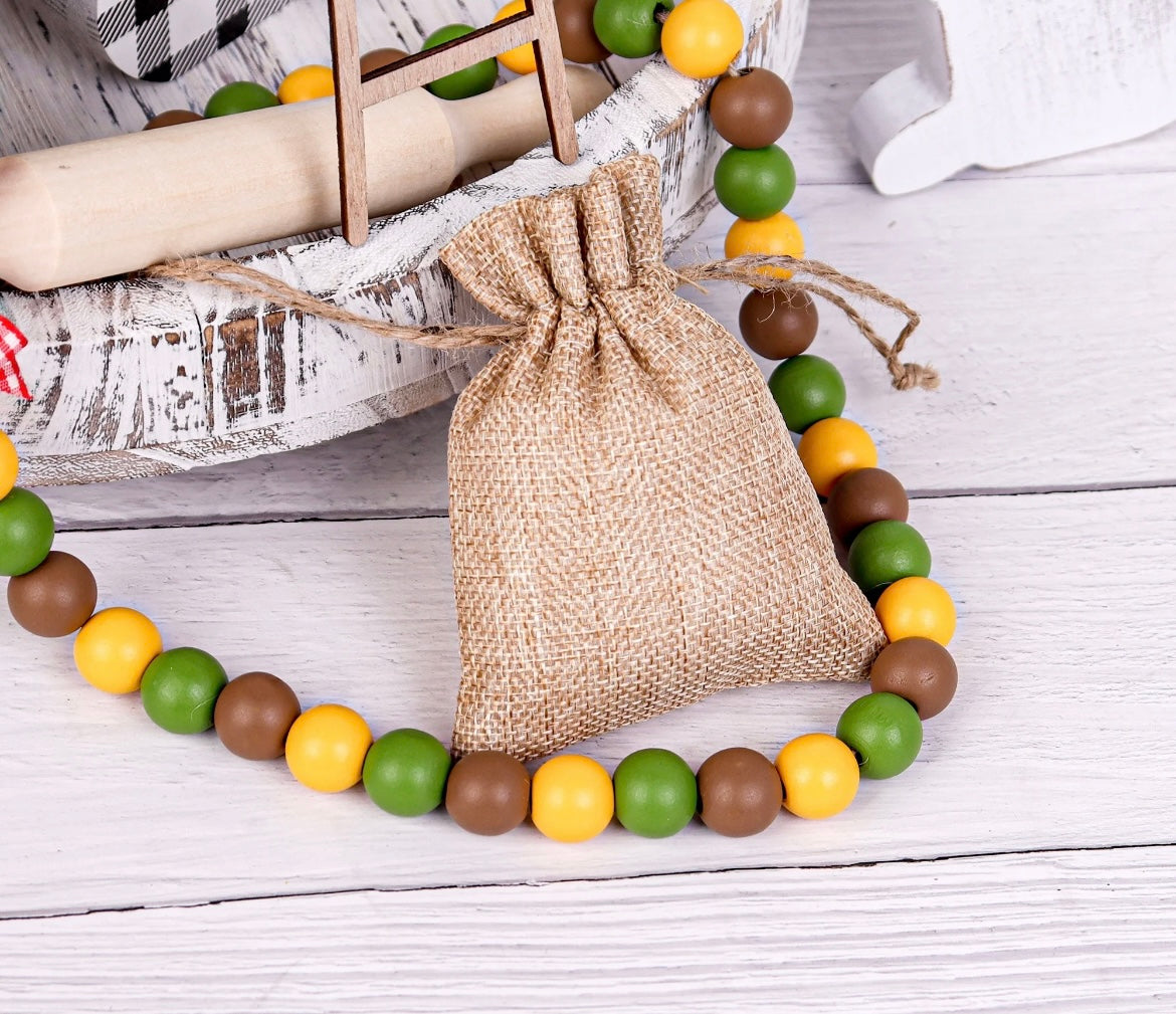 yellow green brown beads on tier tray with jute mini bag