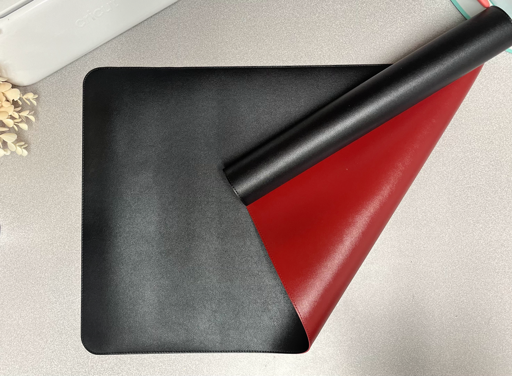 double sided desk mat black and red on grey background