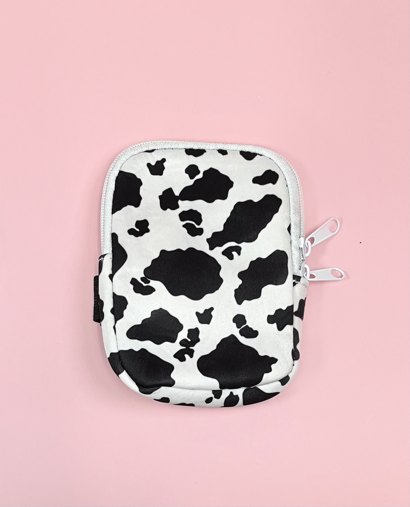 cow print tumbler water bottle pouch with zipper and velcro strap on pink background