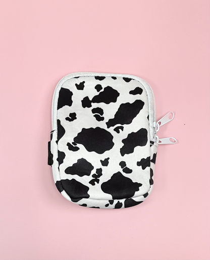 cow print tumbler water bottle pouch with zipper and velcro strap on pink background