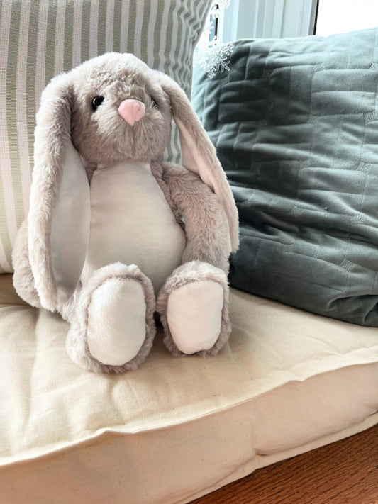 floppy ear grey sublimation bunny sitting on pillow