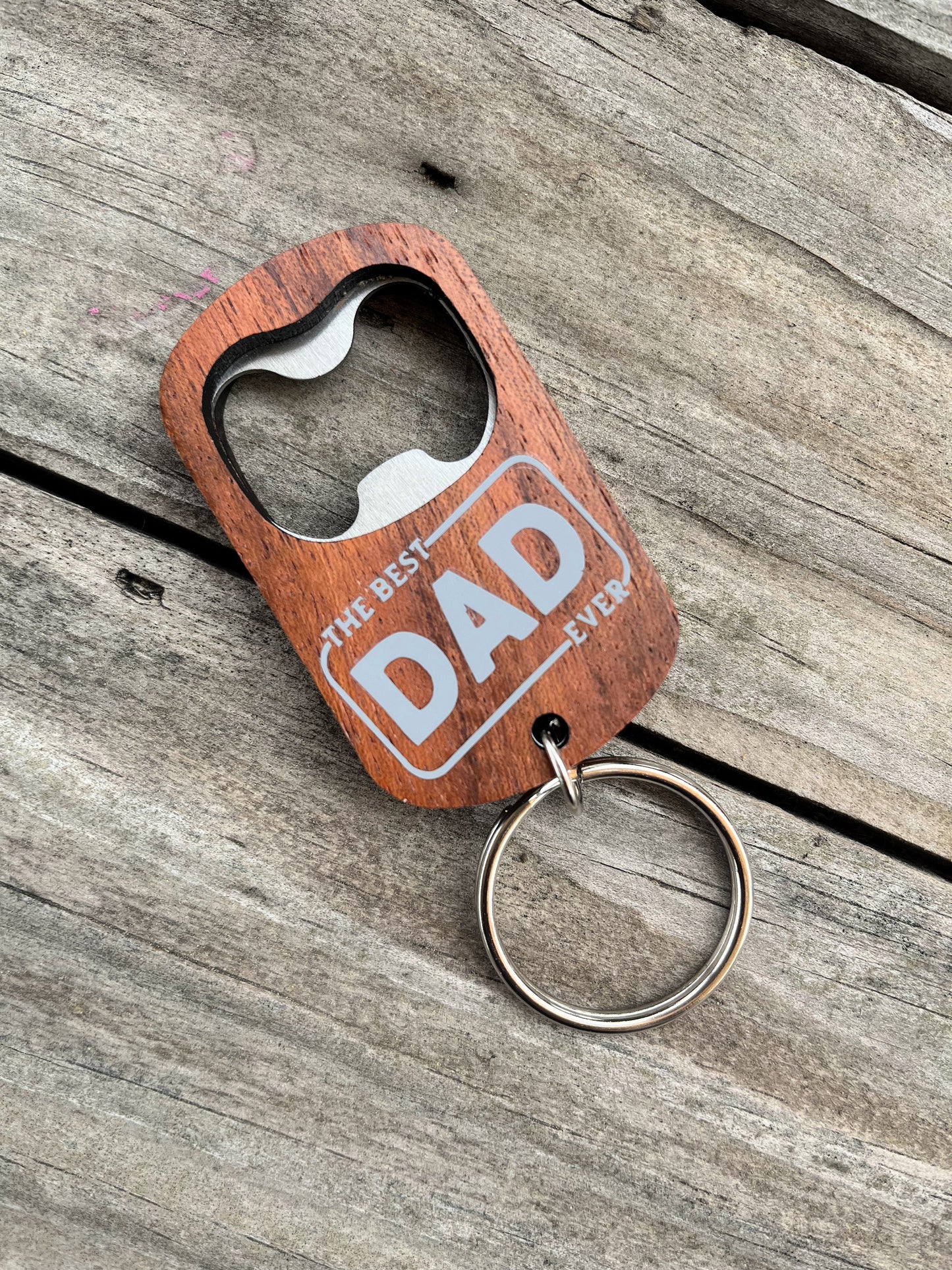 wood best dad every bottle opener key chain on wood background