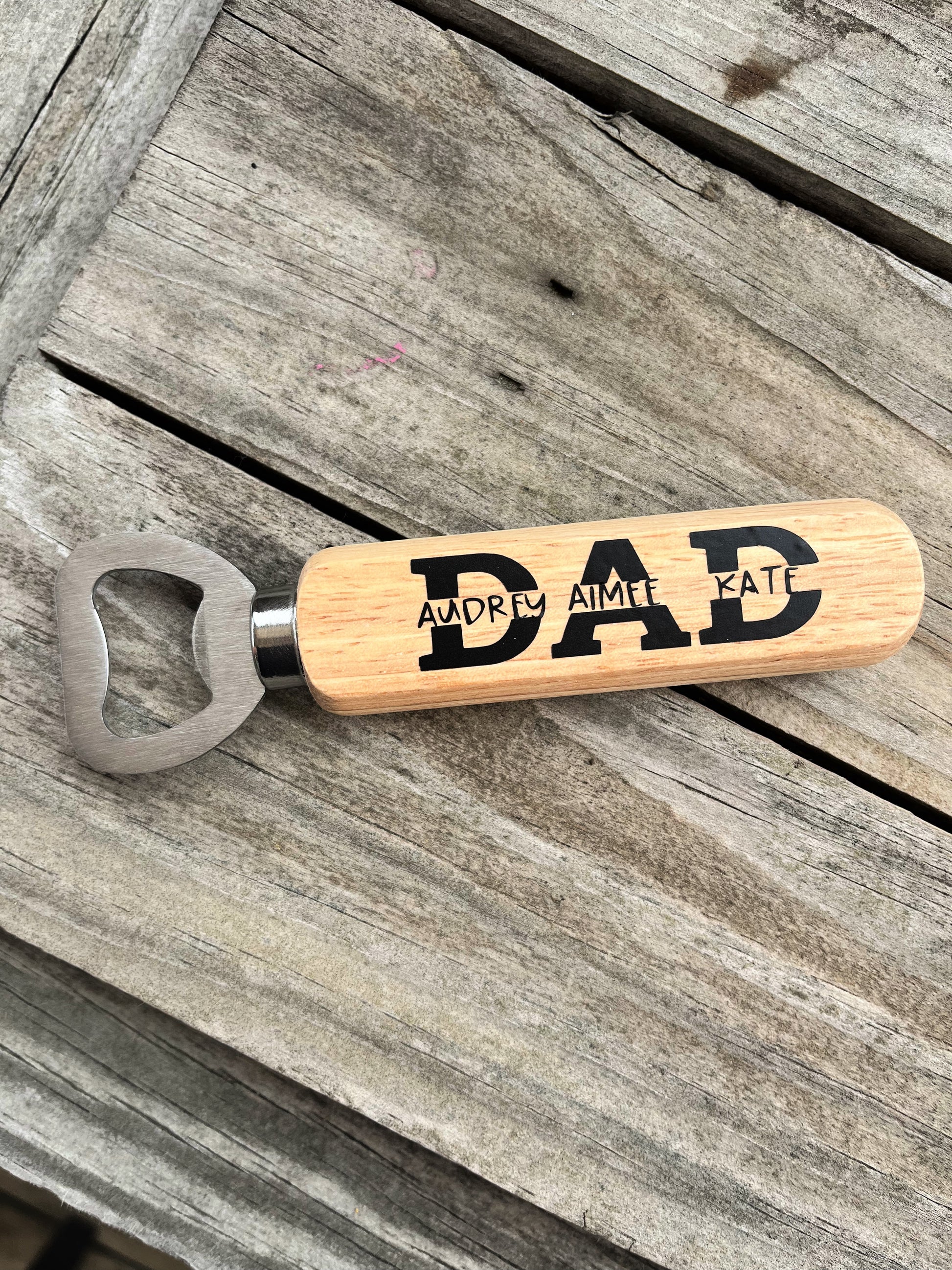 wood handled bottle opener for dad on wood background