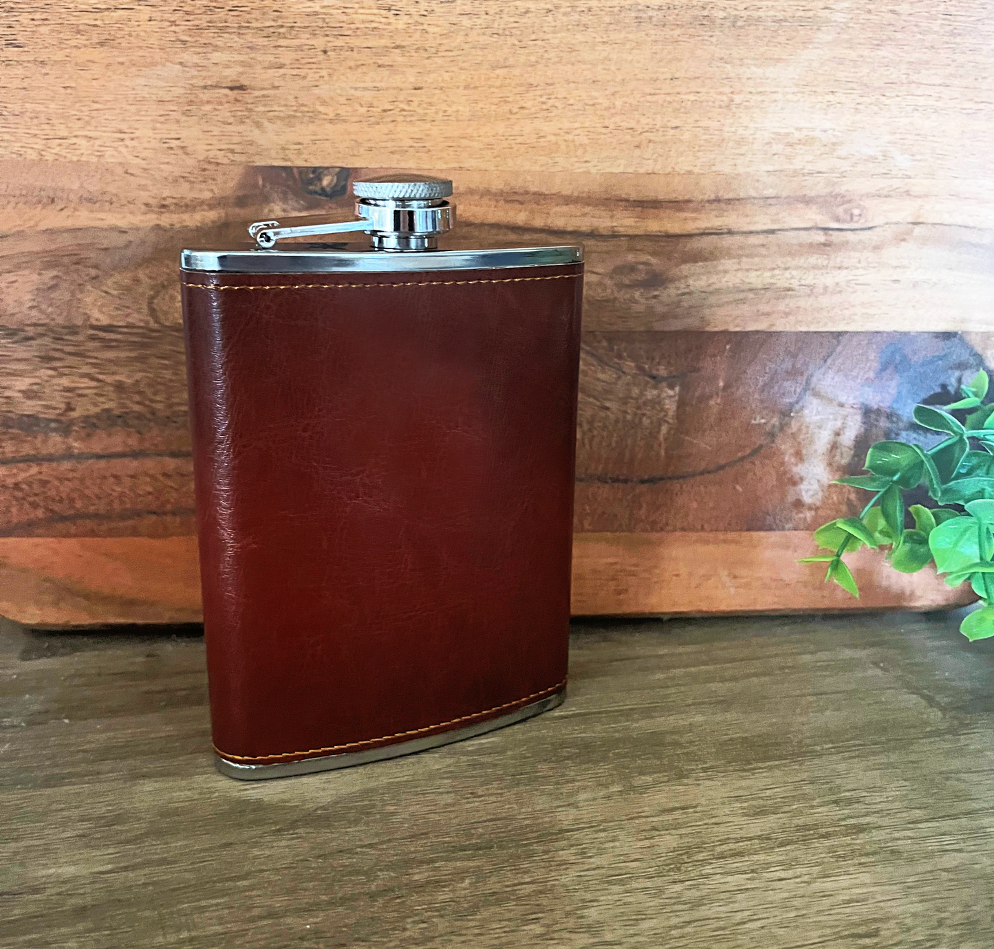 stainless steel 8oz flask with pu leather sleeve on wood background