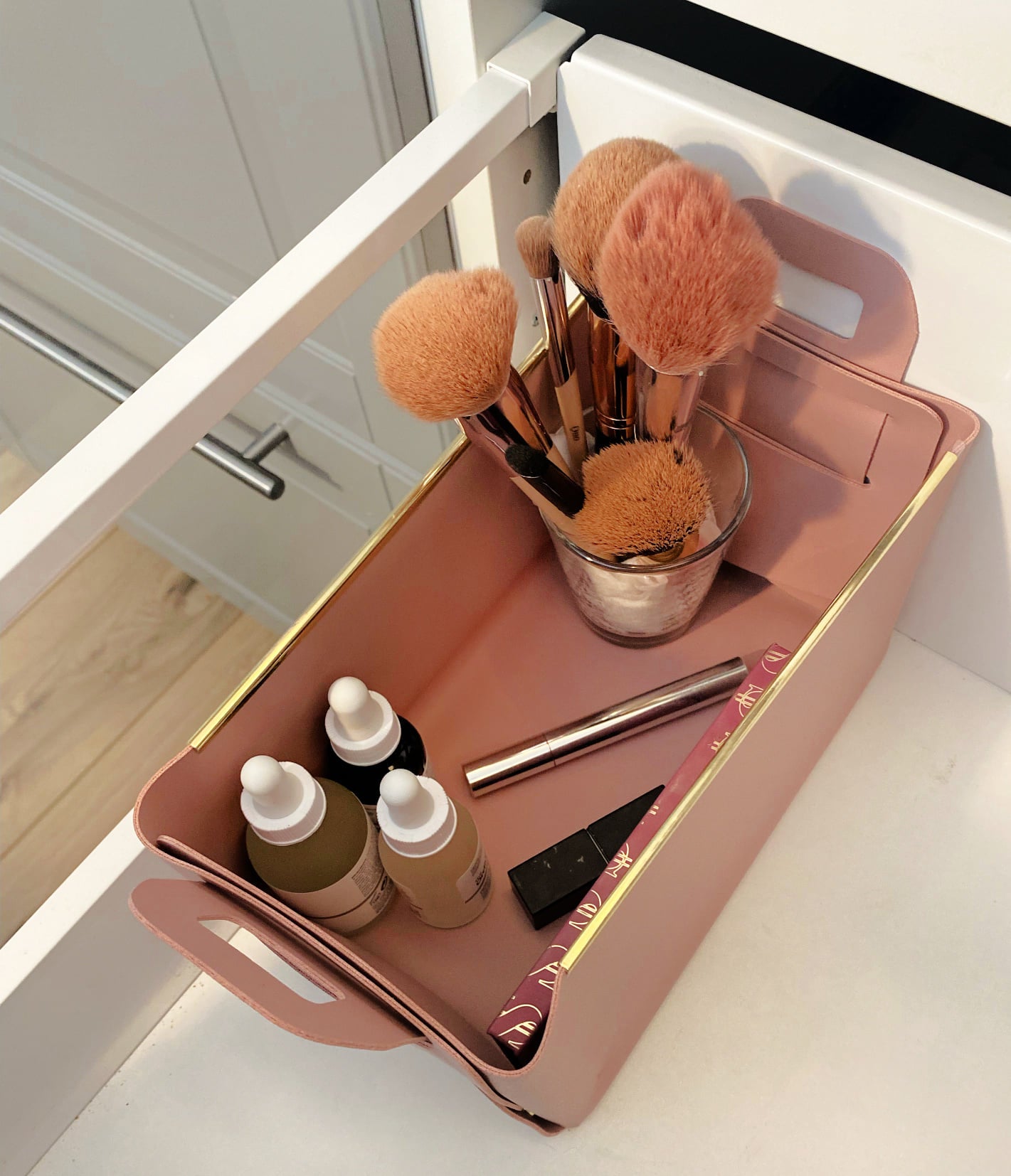 pink leather storage in make up drawer with make up brushes 