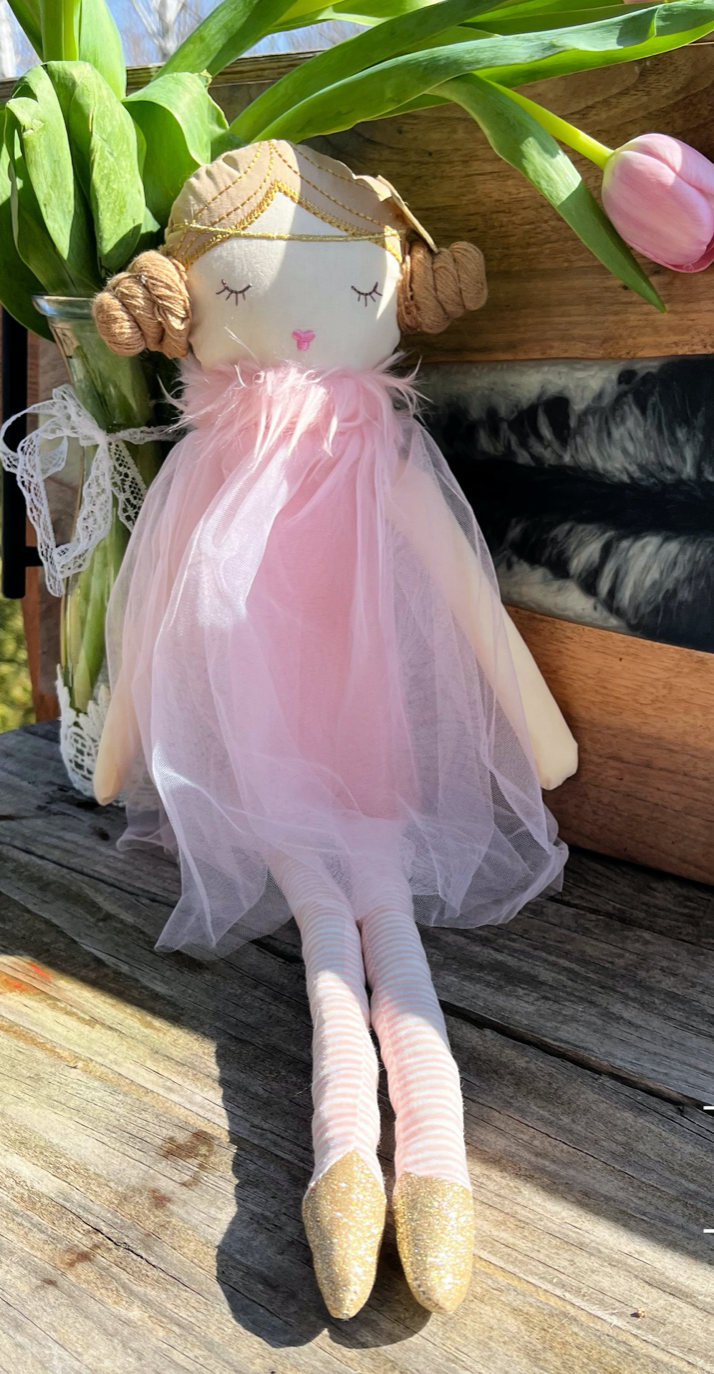 nordic style soft ballerina doll with pink dress and buns in hair by pink tulips