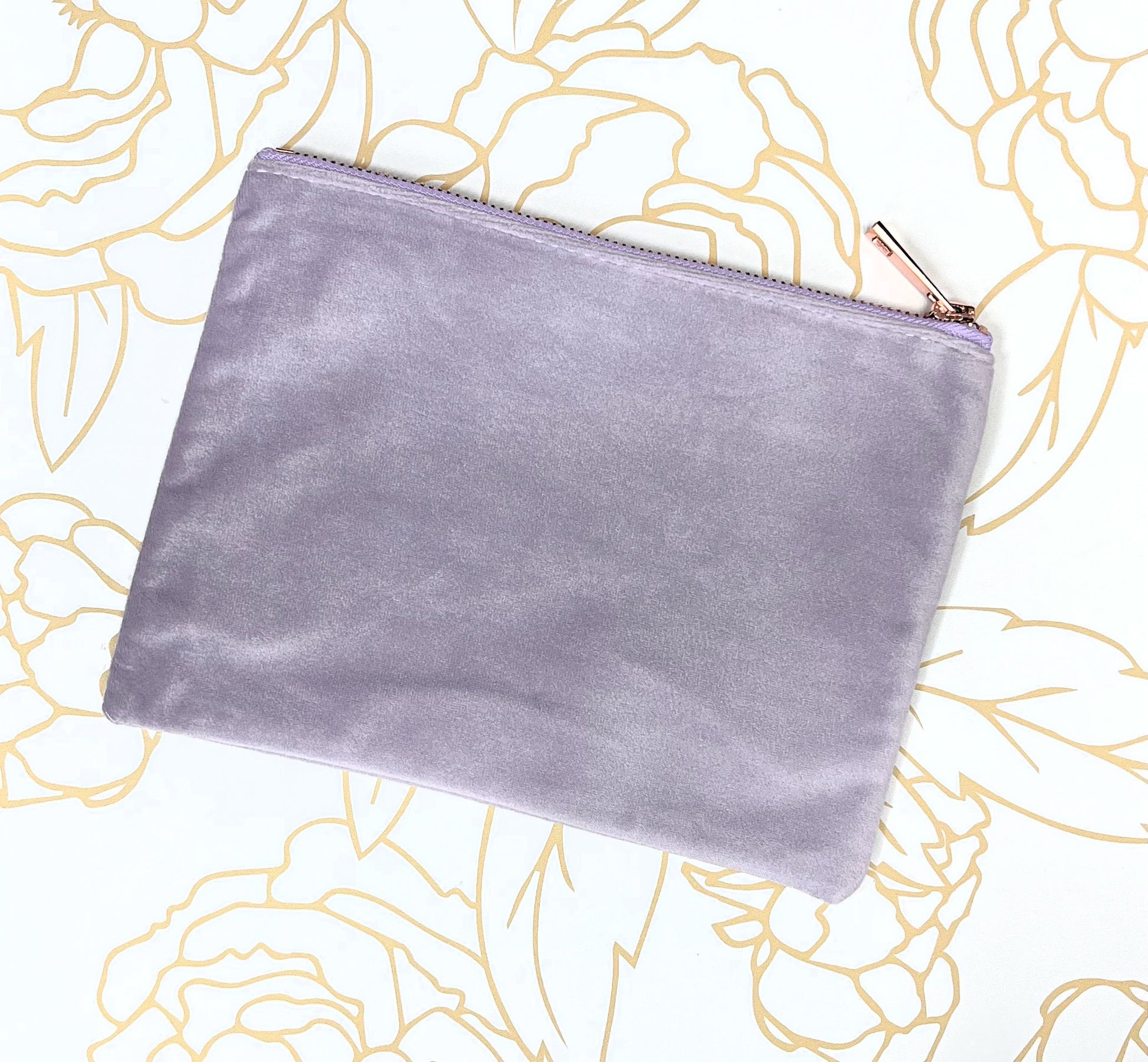 lilac velvet make up case with rose gold zipper on gold flower background