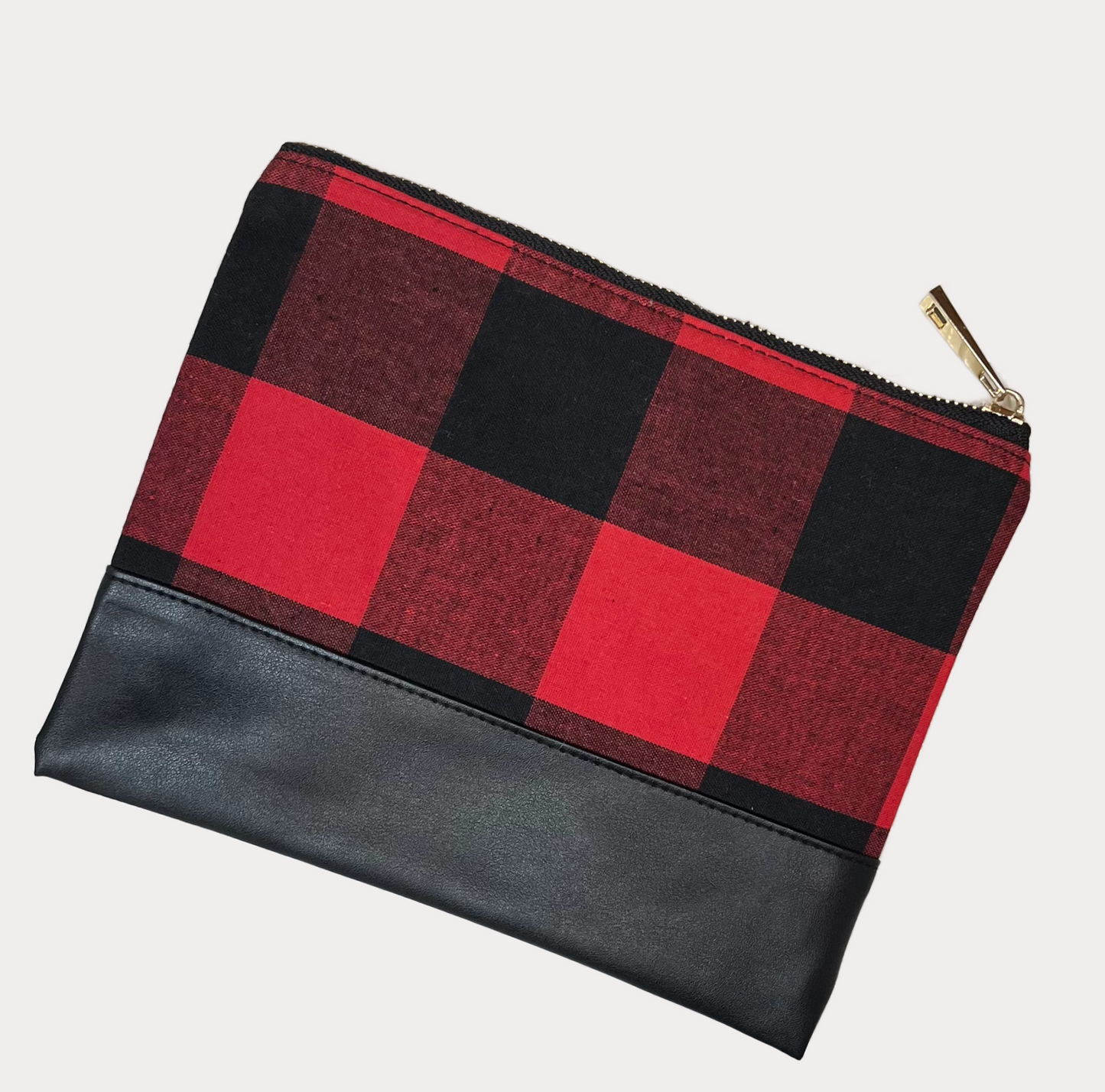 buffalo plaid make up pouch with leather bottom and gold zipper on white background