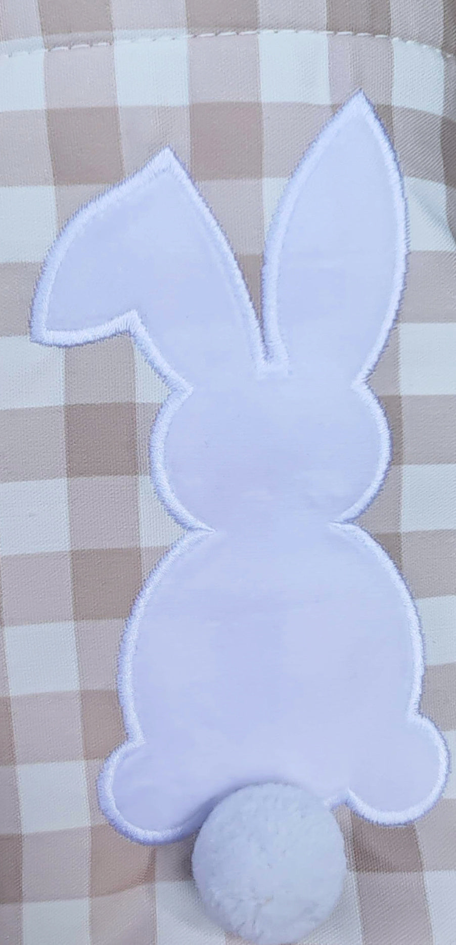 close up of white bunny with Pom Pom tail on Easter basket checkered tan embroidered 