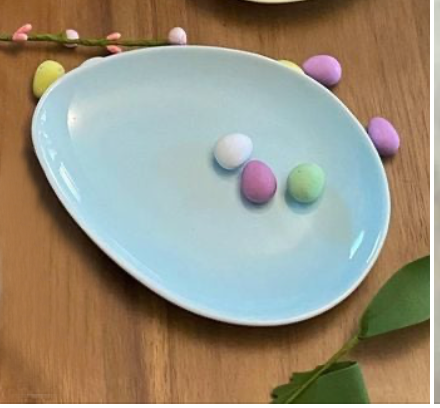 blue ceramic egg plate with candy coloured eggs on top 