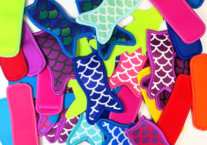 colourful neoprene freeze holders on white background mermaid tails shark tails and rectangles