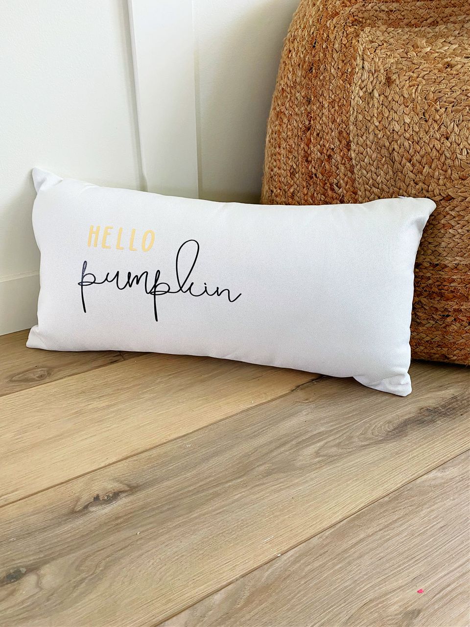 personalized white lumbar pillow hello pumpkin infront of whicker poof 