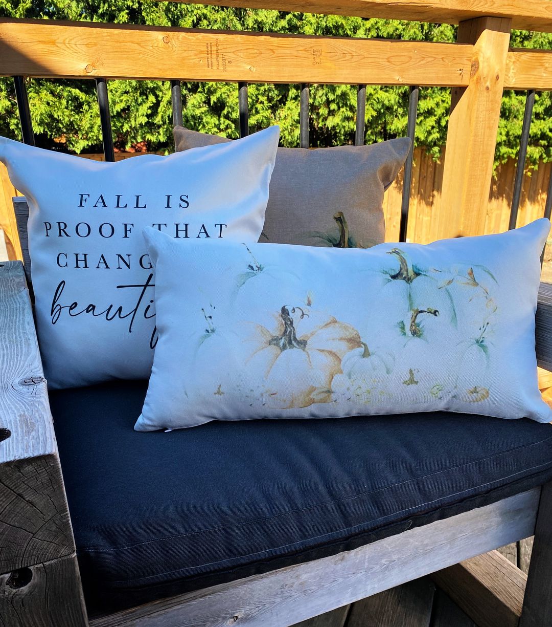 white square pillow white lumbar pillow outside on patio furniture personalized for fall with coloured pumpkins