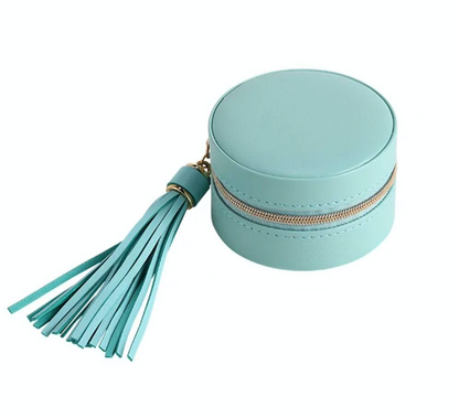 round seafoam jewellery case with gold zipper and matching hassle on white background