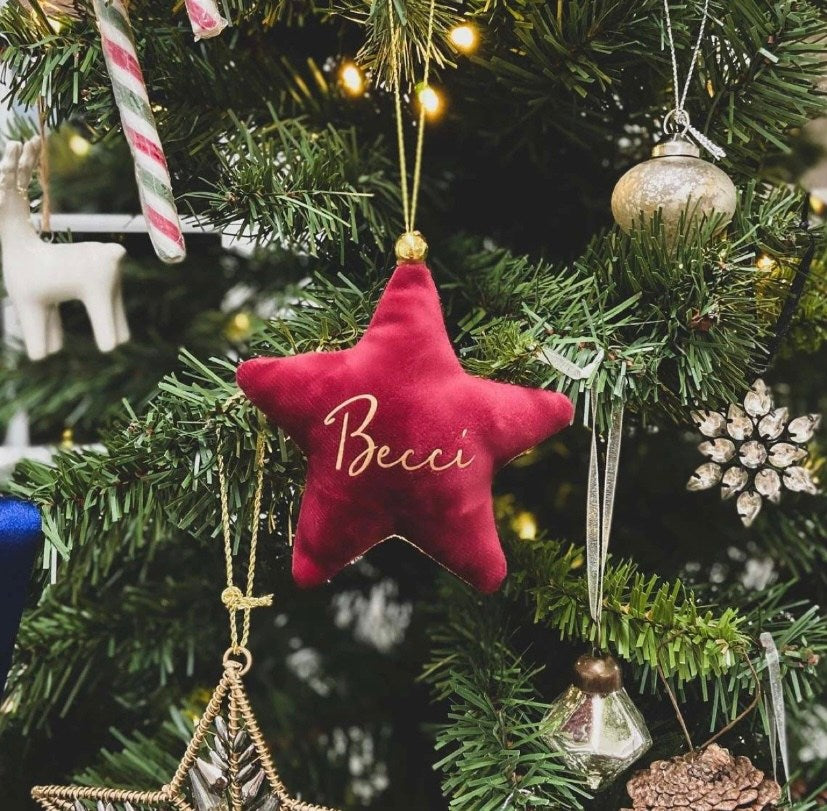 red velvet personalized star on Christmas tree with gold ornaments and candy canes