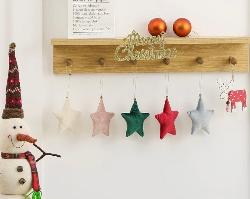 cream rose green red and silver stars hanging on wood hooks Merry Christmas sign and snowman